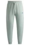 HUGO COTTON-TERRY TRACKSUIT BOTTOMS WITH BLUE LOGO PATCH