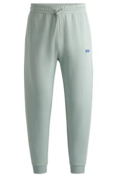 Hugo Cotton-terry Tracksuit Bottoms With Blue Logo Patch In Light Green