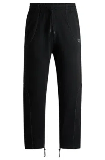 Hugo Boss Cotton-terry Tracksuit Bottoms With Decorative Reflective Trims In Black