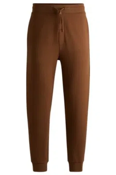 Hugo Boss Cotton-terry Tracksuit Bottoms With Logo Print In Brown