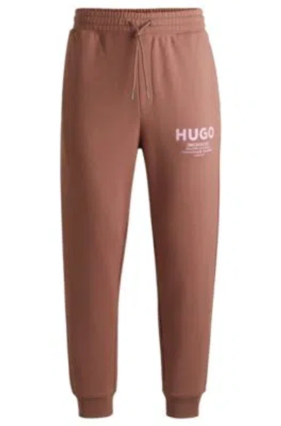 Hugo Boss Cotton-terry Tracksuit Bottoms With Logo Print In Brown