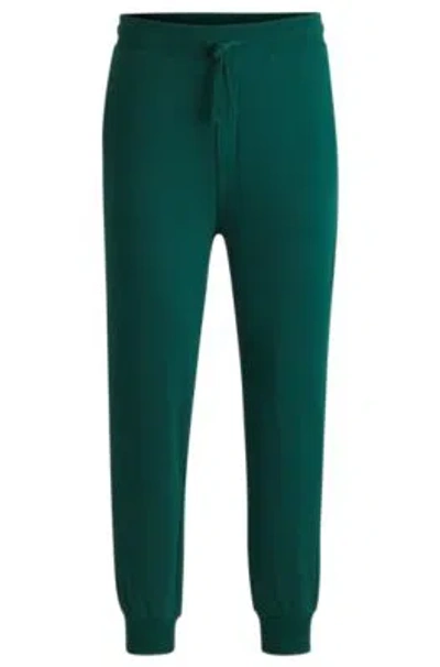 Hugo Boss Cotton-terry Tracksuit Bottoms With Logo Print In Dark Green