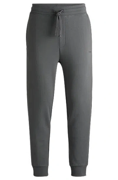 Hugo Boss Cotton-terry Tracksuit Bottoms With Logo Print In Gray