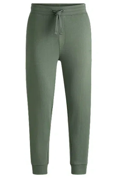 Hugo Boss Cotton-terry Tracksuit Bottoms With Logo Print In Green