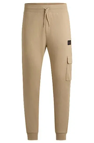 Hugo Boss Cotton-terry Tracksuit Bottoms With Logo Trim In Neutral