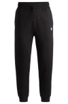HUGO COTTON-TERRY TRACKSUIT BOTTOMS WITH SMILEY-FACE LOGO PATCH