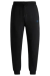 Hugo Boss Cotton-terry Tracksuit Bottoms With Smiley-face Logo Patch In Black