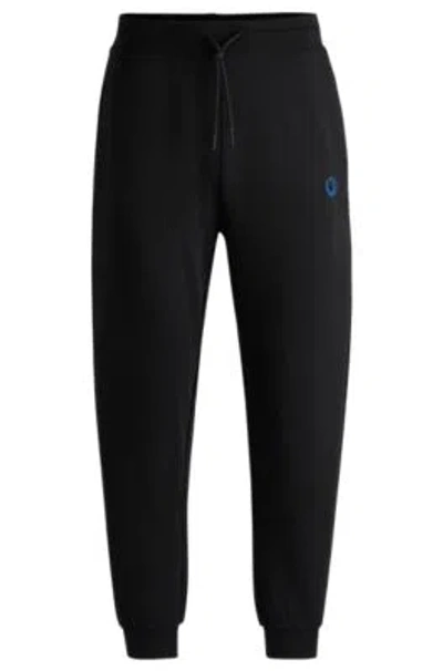 Hugo Boss Cotton-terry Tracksuit Bottoms With Smiley-face Logo Patch In Black