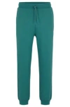 Hugo Cotton-terry Tracksuit Bottoms With Smiley-face Logo Patch In Green