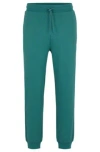Hugo Boss Cotton-terry Tracksuit Bottoms With Smiley-face Logo Patch In Green