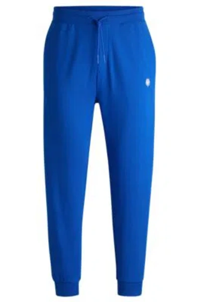 Hugo Boss Cotton-terry Tracksuit Bottoms With Smiley-face Logo Patch In Light Blue