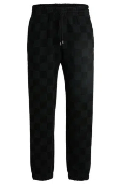 Hugo Loose-fit Tracksuit Bottoms With Checkerboard Print In Black
