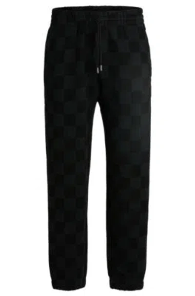 Hugo Boss Loose-fit Tracksuit Bottoms With Checkerboard Print In Black