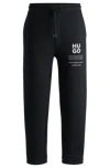 Hugo Boss Relaxed-fit Tracksuit Bottoms With Logo And Slogans In Black