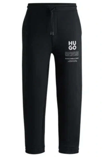 Hugo Boss Relaxed-fit Tracksuit Bottoms With Logo And Slogans In Black