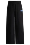 Hugo Relaxed-fit Tracksuit Bottoms With Logo Print In Black