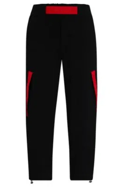 Hugo Relaxed-fit Tracksuit Bottoms With Red Logo Tape In Black