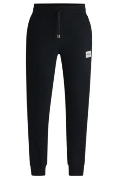 Hugo Boss Tracksuit Bottoms With Metallic Logo Label In Black