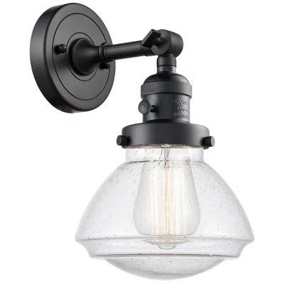 Innovations Lighting Olean 7.75" High Matte Black Sconce W/ Seedy Shade