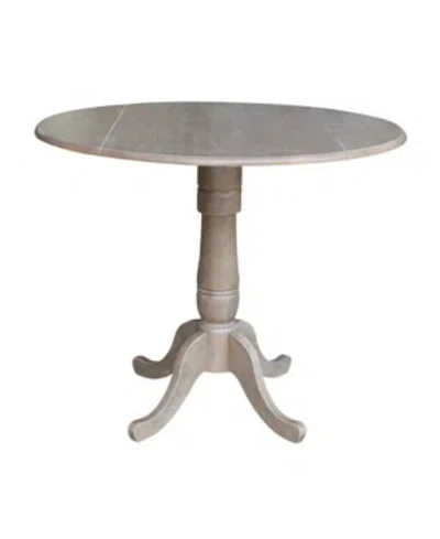 International Concepts 42" Round Dual Drop Leaf Pedestal Table In Gray