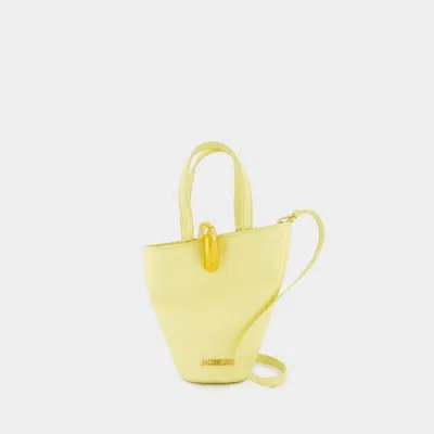 Jacquemus Le Petit Bambola Asymmetric Mini Bucket Bag In Yellow