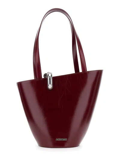 JACQUEMUS JACQUEMUS WOMEN 'LE BAMBOLA MOYEN' BORDEAUX SHOULDER BAG WITH FRONT METAL RING CLOSURE AND EMBOSSED 