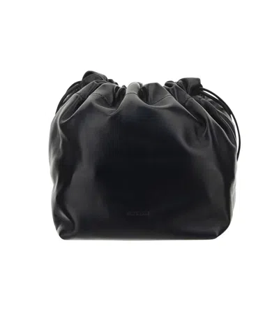 Jil Sander Logo Embossed Drawstring Medium Shoulder Bag In Black