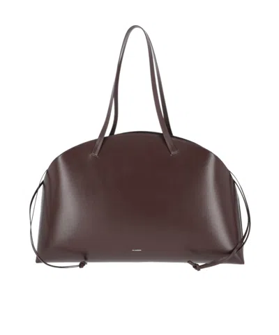 JIL SANDER JIL SANDER LOGO PRINTED DRAWSTRING SHOULDER BAG