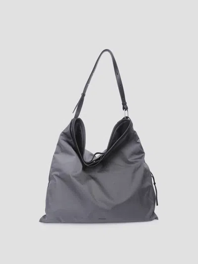 Jil Sander Leather Strap Logo Soft Rolled Bag In Gray