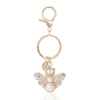 Juicy Couture Regal Bee Pearl Charm Keychain In Gold