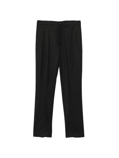 Julius Curved-seam Trousers In Black