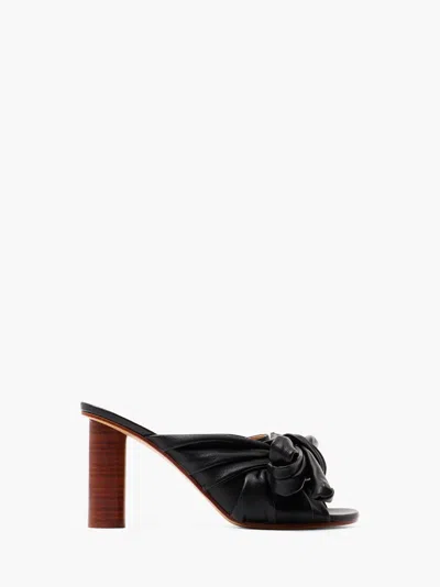 Jw Anderson Bow Heeled Mules In Black