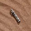 Karma And Luck Tower Of Strength Tube Charm In Metallic