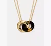 Kate Spade Interlock Small Pendant In Brown