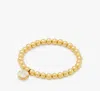 Kate Spade Gold-tone Stone Charm Beaded Stretch Bracelet In Abalone/gold