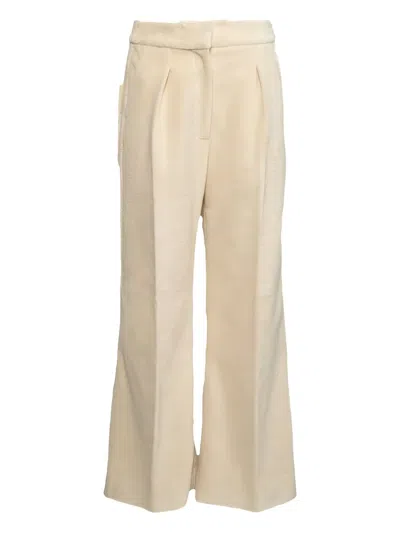 Khaite Pleated-front Trousers In Yellow