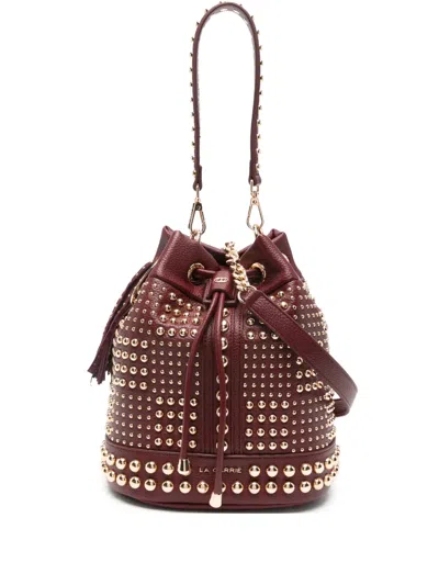 La Carrie Planet Studded Tassel Bucket Bag In Red