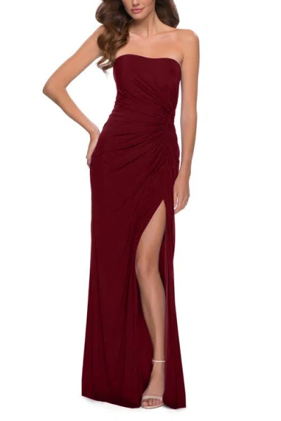 La Femme Strapless Jersey Dress With Ruching And Skirt Slit In Burgundy