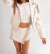 LE LIS ROYCE FAUX LEATHER FRINGE & STUD CROPPED JACKET IN CREAM
