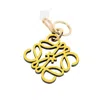 Loewe Anagram Leather And Brass Charm In Yellow/gold Tone