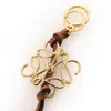 Loewe Gold / Tan Anagram Charm In Calfskin In Gold Tone