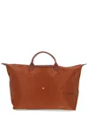Longchamp Foldable Rectangular Travel Bag Top Handles In Brown