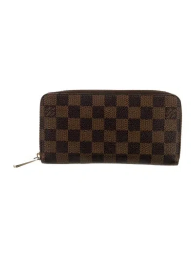 Pre-owned Louis Vuitton 2009 Damier Ebene Pattern Zippy Wallet In Brown