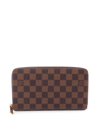Pre-owned Louis Vuitton 2011 Zippy Organiser Damier Ebene Wallet In Brown