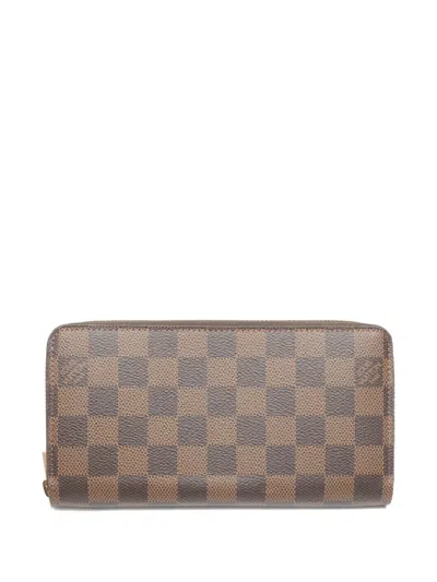 Pre-owned Louis Vuitton 2012 Damier Ebène Zip Wallet In Brown