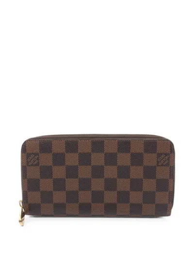 Pre-owned Louis Vuitton 2012 Damier Ebene Zippy Wallet In Brown