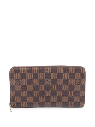 Pre-owned Louis Vuitton 2013 Damier Ebene Zippy Wallet In Brown