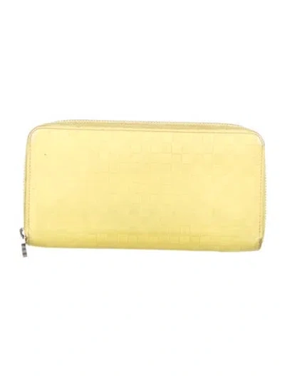 Pre-owned Louis Vuitton 2013 Damier Infini Zippy Wallet In Yellow