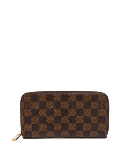 Pre-owned Louis Vuitton 2018 Zippy Damier Ebene Wallet In Brown