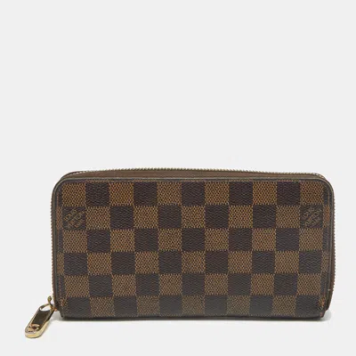Pre-owned Louis Vuitton Damier Ebene Canvas Zippy Wallet In Brown